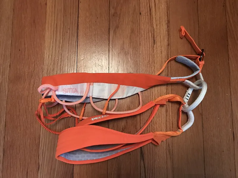 Climbing harness with waist belt and leg loops, illustrating harness rental in El Chaltén