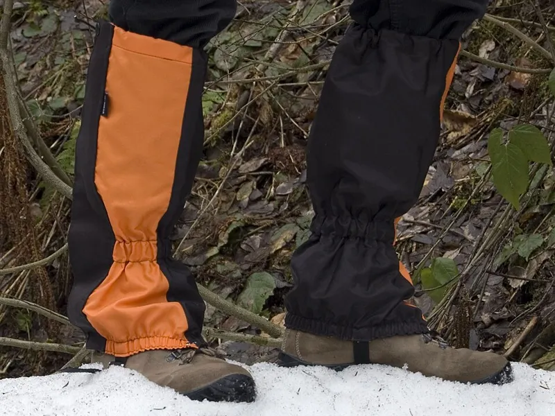 Orange gaiters worn over hiking boots, illustrating gaiter rental in El Chaltén