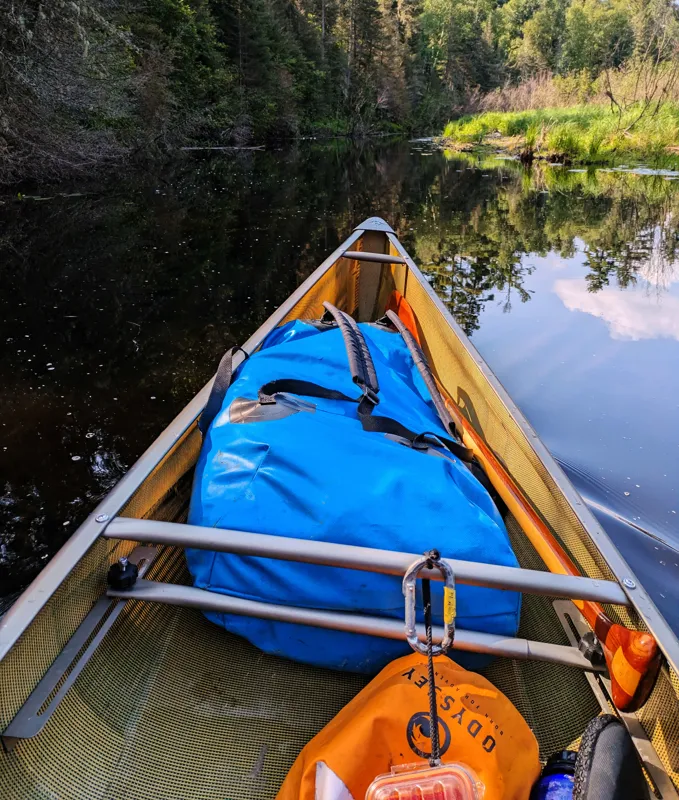 Dry bags packed in a canoe, illustrating waterproof dry bag rental in El Chaltén