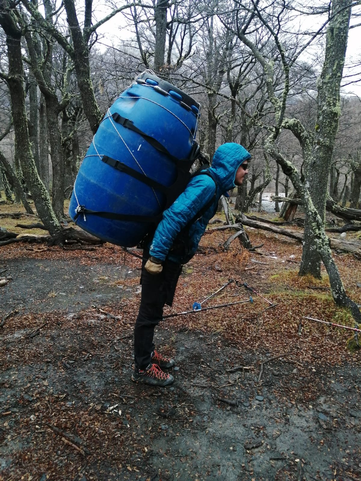 porter carrying gear in blue container